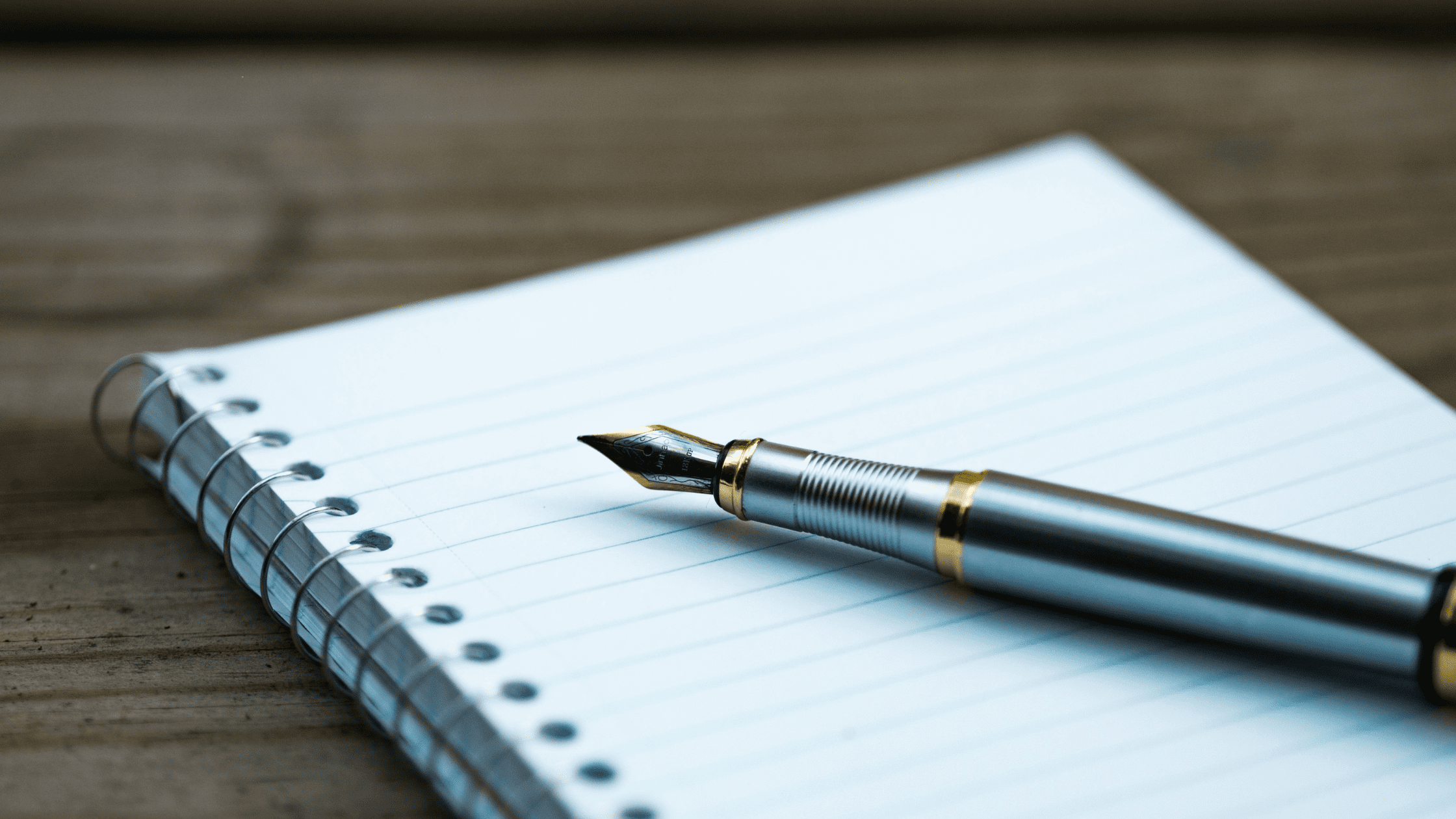 A photo of a notebook and pen for writing your medical school letter of intent.